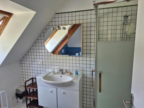 a bathroom with a sink and a mirror at Chambre, Terrasse et Jacuzzi in LʼÉtang-la-Ville