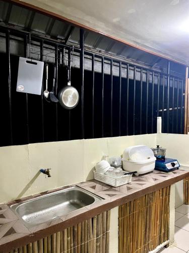 a kitchen with a sink and a counter top at Casa Huway in El Nido