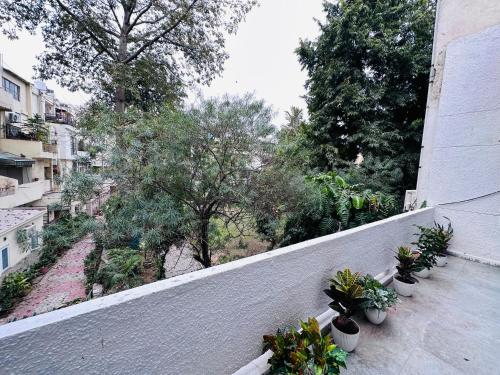 a balcony with potted plants on a building at Grove Residency Hauz Khas Couple Friendly New Delhi in New Delhi