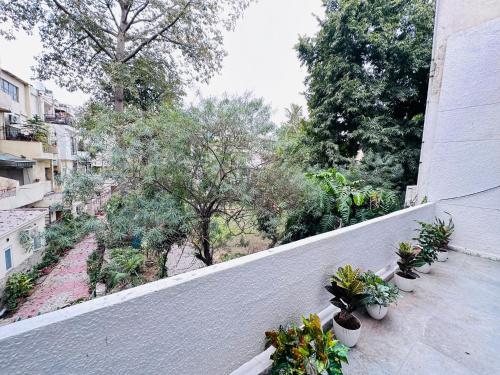 a balcony with potted plants on the side of a building at Grove Residency Hauz Khas Couple Friendly New Delhi in New Delhi