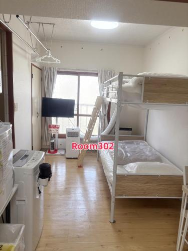 Postel nebo postele na pokoji v ubytování Tao House 地下鉄から徒歩約30秒 札幌大通すすきの駅直通 空港や小樽行高速バス有