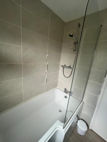 a bathroom with a shower and a bath tub at 3 bed self contained part house in Queensferry, Edinburgh in Queensferry