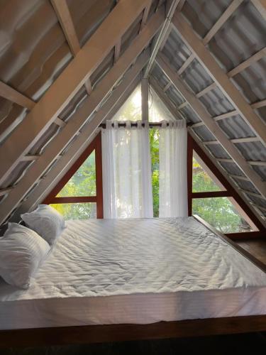 a large bed in a room with a window at Waves Floating Villa in Ambalangoda