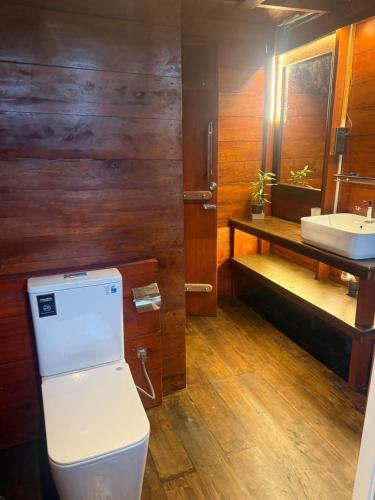 a bathroom with a toilet and a sink at Waves Floating Villa in Ambalangoda