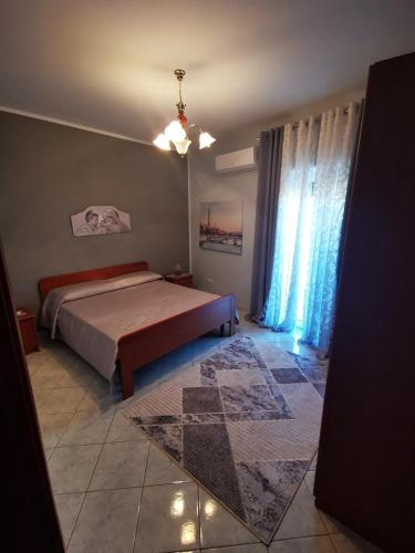 a bedroom with a bed and a large window at Blu Amalfi in Gizzeria