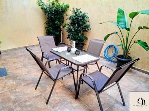 a table and chairs in a room with plants at La casa bella di Chalkida 2 in Chalkida