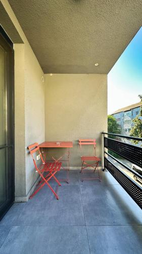 a table and two chairs sitting on a balcony at Timisoara Prime Residence - powered by NEO - private parking in Timişoara