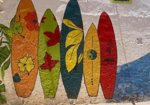 a row of surfboards lined up against a wall at Dar Mogador Sun near Taghazout - Surf, Sea, colorful village in Taghazout