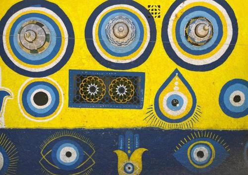 a yellow background with blue and white patterns on it at Dar Mogador Sun near Taghazout - Surf, Sea, colorful village in Taghazout