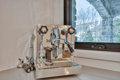 a coffee maker sitting on a counter next to a window at Tremblant mountain view in Mont-Tremblant