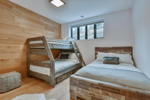 a bedroom with two bunk beds and a window at Tremblant mountain view in Mont-Tremblant