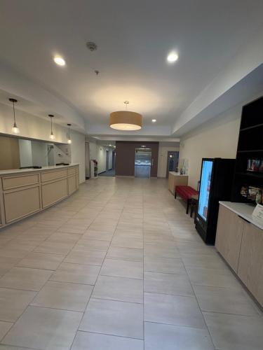 an empty lobby of a hospital with a flat screen tv at Tapa Hotel, Inn & Suites in Mahwah