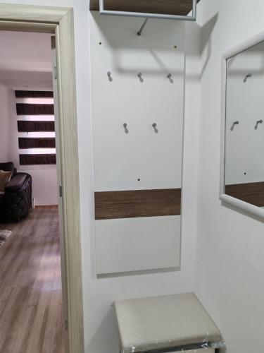 a room with white walls and a mirror at Sveti Luka- OBRADOVIĆ SOKAK 41 in Šimanovci