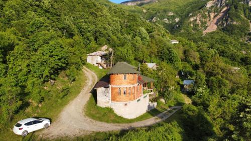 a white car parked in front of a building on a hill at Villa Gorno Melnicani in Debar