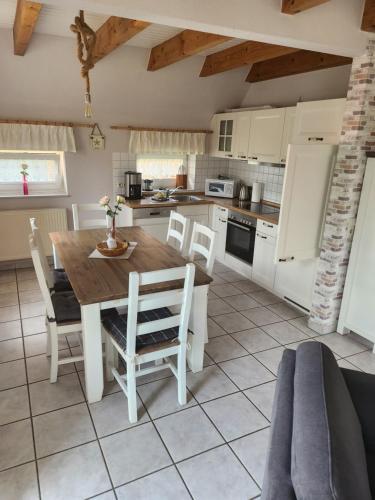 a kitchen and dining room with a table and chairs at Haus Max in Dornum