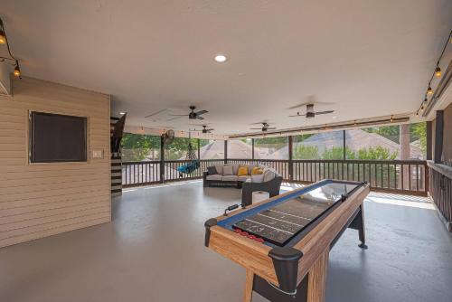 a living room with a pool table on a deck at "Fitz-Just-Right" Family-Friendly Fun, Games! in Honea