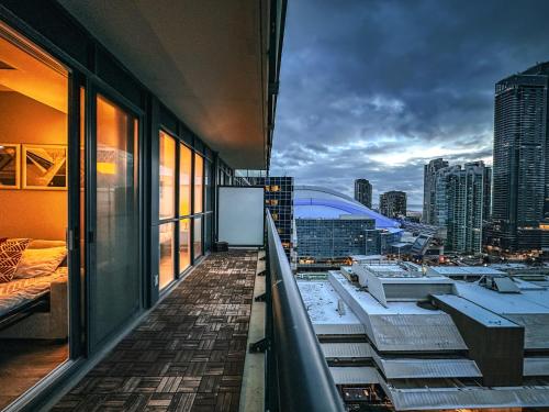 a balcony of a building with a view of a city at Comfy Front Wellington Suites CN Tower Rogers Centre & Free Parking in Toronto