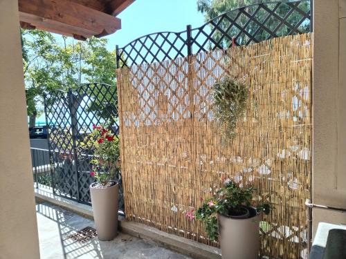 a fence with two potted plants on it at Villa Marini in Trevignano Romano