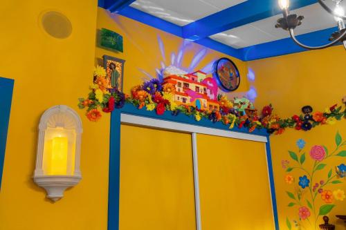 a yellow room with a building on top of a door at Enchanted Dreams: Theater, Arcades, Playground + in Neff