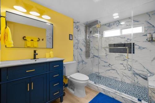 a bathroom with a sink and a toilet and a shower at Enchanted Dreams: Theater, Arcades, Playground + in Neff