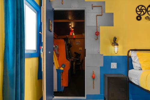 a room with a bedroom with a bed and a room with a door at Enchanted Dreams: Theater, Arcades, Playground + in Neff