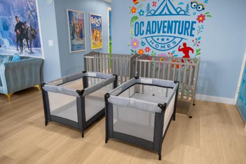 a nursery with two cribs in a room at Enchanted Dreams: Theater, Arcades, Playground + in Neff