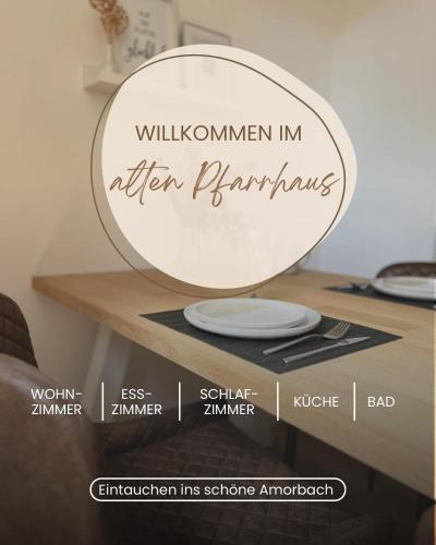 a mirror with the words willuminemen in eighteen bathrooms at Altes Pfarrhaus Amorbach in Amorbach