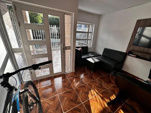 a living room with a bike and a couch at Apartamento Playa Serena in San Antero