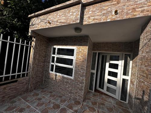 a brick building with two windows and a door at Apartamento Playa Serena in San Antero