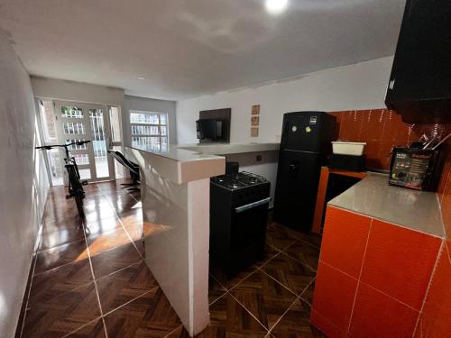 a kitchen with a black refrigerator and a stove at Apartamento Playa Serena in San Antero