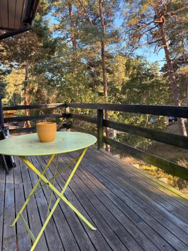 a table on a deck with a bowl on it at Villa Villekulla in Åhus