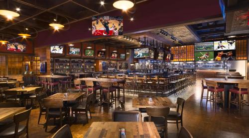 a restaurant with tables and chairs and a bar at SPHERE VIEW - Signature MGM Resort Lucky Gem Penthouse & Luxury Suites 10817 in Las Vegas