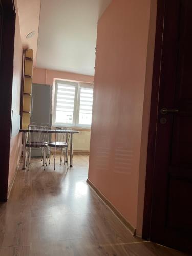 a room with a table and a table and chairs at 2-jų kambarių nuoma in Mažeikiai