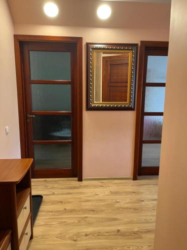 a room with two doors and a mirror on the wall at 2-jų kambarių nuoma in Mažeikiai