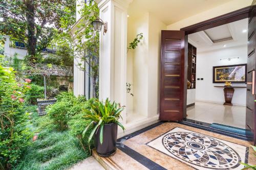 a front door of a house with plants at Lumiere Villa Splendora An Khánh in Vân Lũng