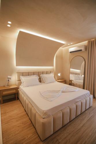 a bedroom with a large bed and a mirror at The Wish Houses in Golem