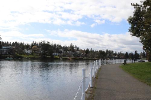 a path next to a river with a fence at Victoria Gorge Waterway Vacation Home in Victoria