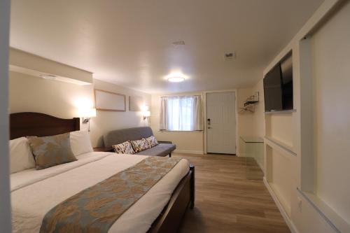 a hotel room with a bed and a couch at Victoria Gorge Waterway Vacation Home in Victoria