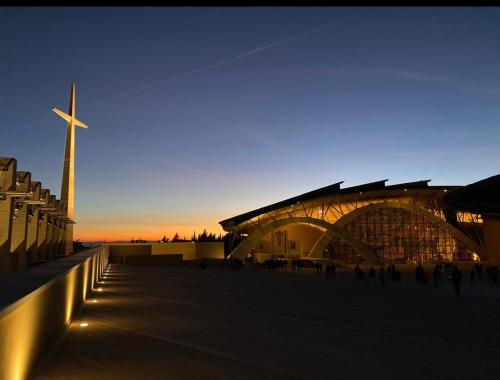 a large building with a cross in front of it at Hotel San Francesco in San Giovanni Rotondo