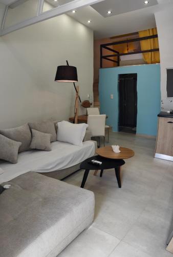 a living room with a couch and a table at LEFKAS CITY APARTMENTS & Suites in Lefkada Town