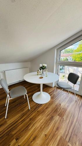a living room with a white table and two chairs at Luxury Apartment in Böblingen in Böblingen