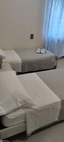 two beds are in a room with a window at BeB575 in Messina
