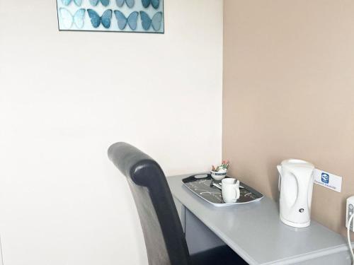 a table in a room with a coffee maker on it at Esk Vale Guest House in Portsmouth
