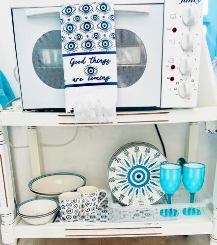 a shelf filled with plates and cups and dishes at Oia Sunset House Pothitou in Oia