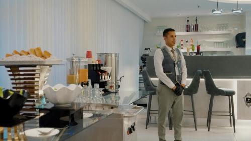 a man standing in front of a counter in a kitchen at Casablanca Elite in Jeddah