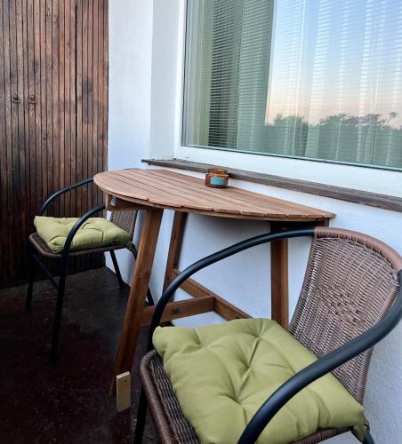 a table and two chairs and a table and a window at Lakeview Retreat in Vievis in Vievis