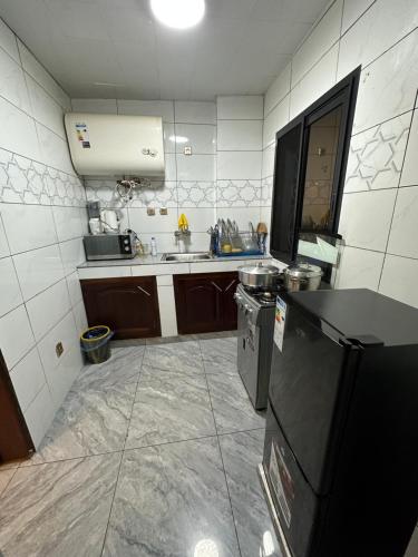 a small kitchen with a sink and a stove at B&B apartments in Yaoundé