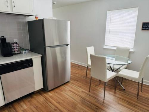 eine Küche mit einem Kühlschrank sowie einem Tisch und Stühlen in der Unterkunft DukeHaven near Northlake, Uptown, Route to Airport in Charlotte