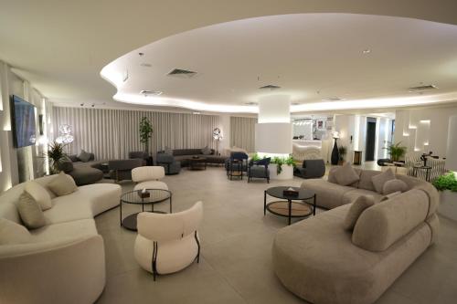 a large living room with couches and chairs and tables at Casablanca Elite in Jeddah