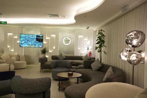 a lobby with couches and chairs and a tv at Casablanca Elite in Jeddah